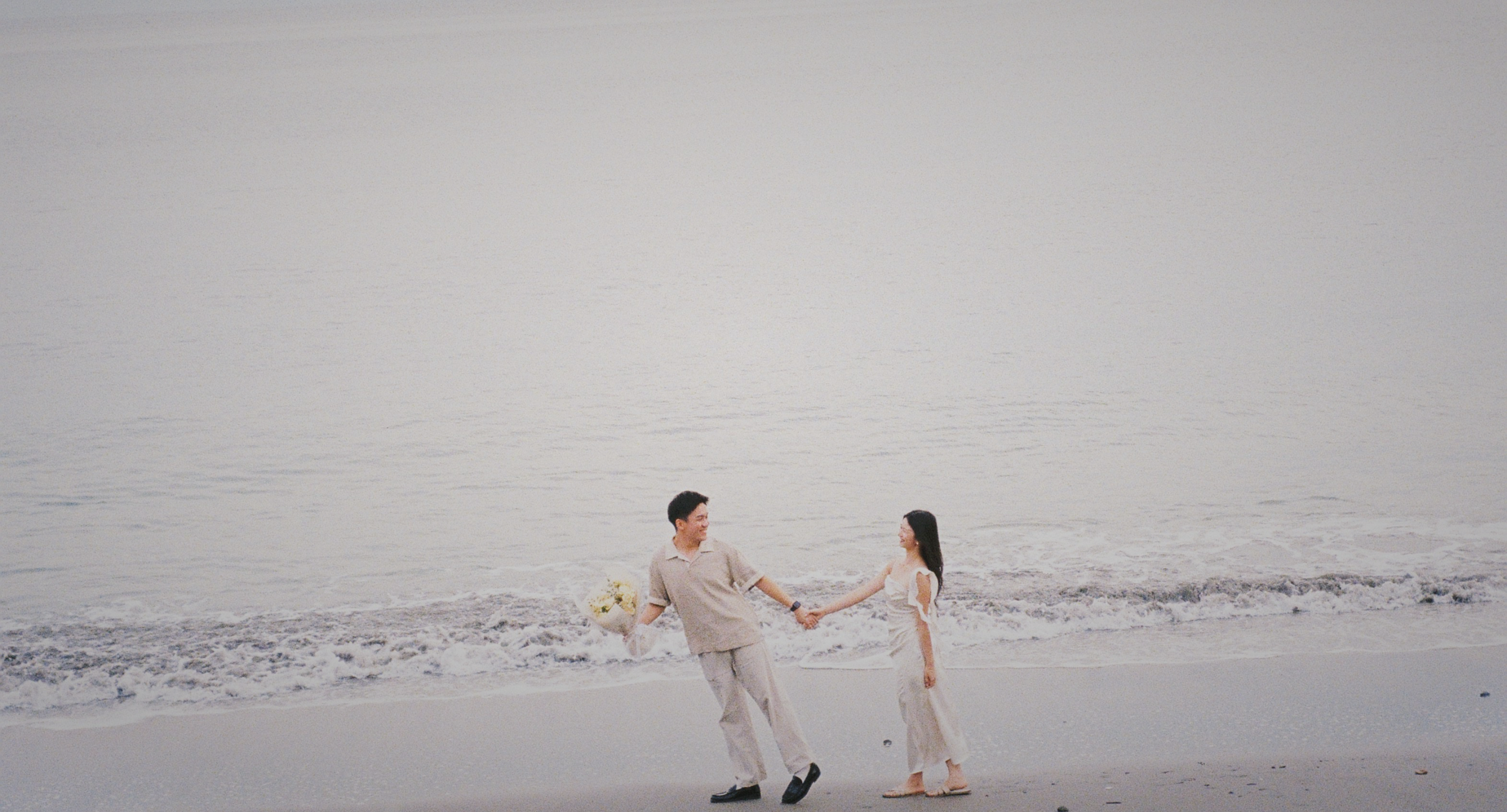 KC and Cynthia walking together on the beach
